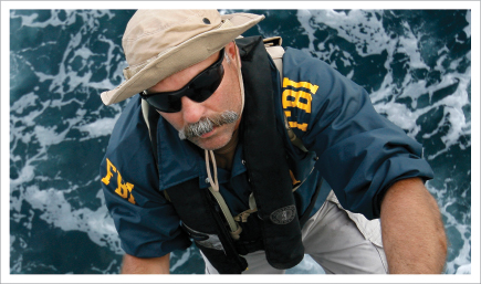 FBI agent climbing up stairs on a boat