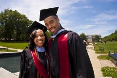 Woman and Man smiling in graduation gear