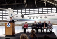 Secretary Locke and officials at airport with NOAA plane in background. Click for alrger image