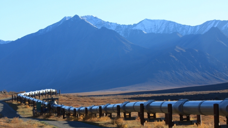 A pipeline in front of a mountain range.