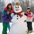 A family standing next to a snowman