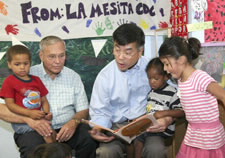 Secretary Locke is shown reading to children with Rep. Harry Mitchell. Photo courtesy Tracy Hayes. Click for larger image.