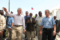 Presidents George W. Bush and Bill Clinton survey damage en route to Palace West Camp during a visit to Haiti on March 22, 2010.