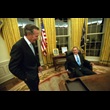 President George W. Bush sits at his desk in the Oval Office for the first time on Inaugural Day.  He talks with his father, former President George H.W. Bush. (P42-13)