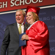 President George W. Bush shares a smile with Megan Booth, May 4, 2008, after presenting her diploma during commencement exercises for the Greensburg High School Class of 2008. The Kansas town was nearly destroyed by a tornado in 2007. (P050408CG-0627)