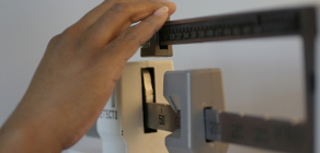 close up of female hand adjusting scale