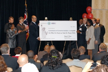 Director Hinson and officials shown with presentation check