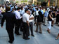 Photo of a crowd of people outside New York's Wall Street.