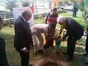 Secretary Bryson Planting a Tree at a new Mahindra World City Development
