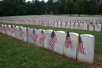 NPS/Andersonville National Historic Site. Flags decorate the graves in Section E of the Andersonville National Cemetery