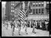 Four color guard from 372nd Infantry marching in front of soldiers