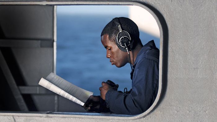 A Yeoman Seaman studies advanced qualifications while standing by.