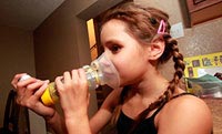 Emily Gorospe uses an inhaler to help alleviate her valley fever symptoms. 