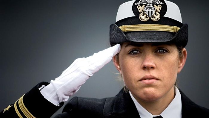 Ship's Navigator renders honors to the national anthem