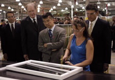 President Mark Savan, Senator Rockefeller, Secretary Locke Governor Manchin watch as a plant work er demonstrates a product. Click for larger image.