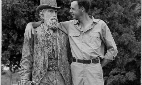 Wendell Berry with arm around statue