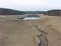reservoir with most of the water dried out due to drought