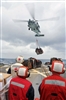 An MH-60S Seahawk helicopter delivers cargo during a vertical replenishment at sea