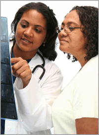 A photo of a doctor and patient discussing an x-ray.