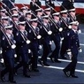 Uniformed individuals marching. 