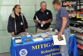 Hazard Mitigation Specialists sharing information in damaged counties to instruct rebuilders about safer rebuilding techniques.