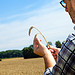 Farmer in wheat field inspecting wheat