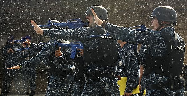 Sailors assigned to the aircraft carrier USS Nimitz (CVN 68) practice maneuvers in the rain during a force protection exercise which incorporated realistic training scenarios and special effects. The U.S. Navy is reliable, flexible, and ready to respond worldwide on, above, and below the sea. Join the conversation on social media using #warfighting.  U.S. Navy photo by Mass Communication Specialist 3rd Class Ryan J. Mayes (Released)  121011-N-RC246-681