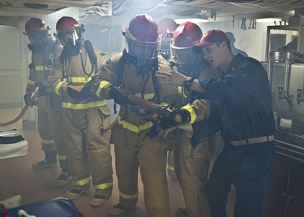 Chief Hull Maintenance Technician Joshua Boleti, right, assigned to the amphibious transport dock ship USS New York (LPD 21), instructs Sailors during a simulated fire on the mess decks. New York is part of the Iwo Jima Amphibious Ready Group with the embarked 24th Marine Expeditionary Unit (24th MEU) and is deployed in support of maritime security operations and theater security cooperation efforts in the U.S. 5th Fleet area of responsibility. The U.S. Navy is reliable, flexible, and ready to respond worldwide on, above, and below the sea. Join the conversation on social media using #warfighting.  U.S. Navy photo by Mass Communication Specialist 2nd Class Ian Carver (Released)  121011-N-XK513-083