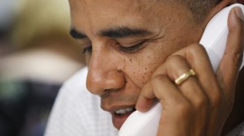 U.S. President Barack Obama calls local campaign volunteers to thank them from his campaign office in Williamsburg, Virginia, October 14, 2012. REUTERS/Jonathan Ernst