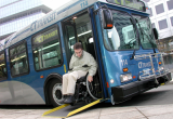 A man in a wheelchair exiting a bus
