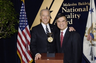 Biden and Locke pose on podium