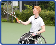 man in a wheelchair playing tennis
