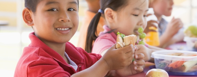 A student eating a school lunch.