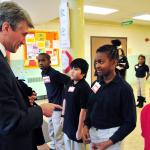 Minneapolis Mayor R.T. Rybak is greeted by Elizabeth Hall International Elementary School 5th graders as he arrives for the Promise Neighborhoods grant announcement. Photo by Bre McGee for the U.S. Department of Education.