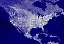Satellite image of North America at night showing electrical illumniation and outline of grid. Click for larger image.