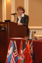 a photo of Dr. Cristina Rabadán-Diehl standing at a podium.