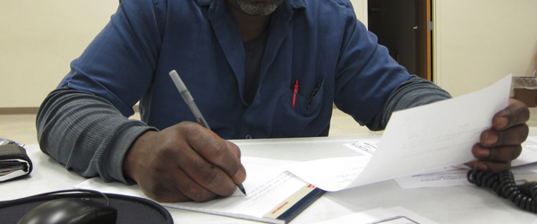 A man filling out Federal assistance paperwork.