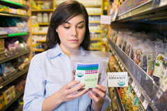 girl checking the label of a bag of nuts