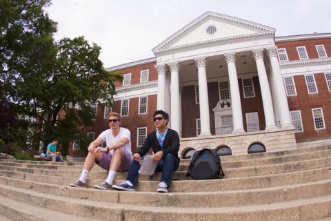 Two students sitting on steps