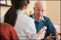 Photo: A man discussing his medication with a healthcare professional.