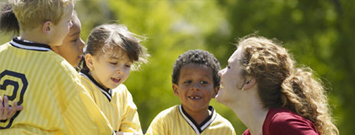 Photo: A coach talking to her young athletes