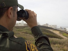 Border patrolman with binoculars