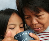 Grandmother and grandchild looking into a cup