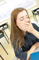 teen girl yawning in classroom