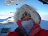 Tia Ferguson in a red coat with a furry hood in Antarctica