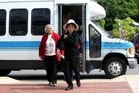 Two women exiting from a mini-bus. - Click to enlarge in new window.