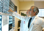 a photo of Dr. Nasser Altorki viewing CT scans on a lightbox.