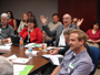 a photo of a groupd a people sitting in a conference room.