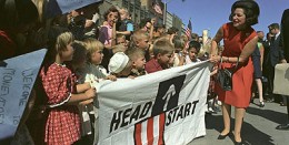 Woman with kids holding Head Start banner