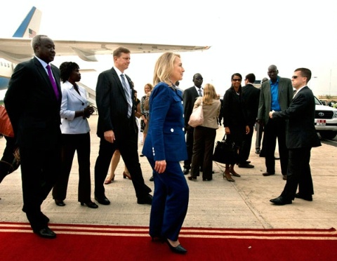 Date: 08/03/2012 Location: Juba, South Sudan Description: U.S. Secretary of State Hillary Rodham Clinton (center) and South Sudan Foreign Minister Nhial Deng Nhial (far left) walk to a vehicle escorted by members of her Diplomatic Security protective detail (third from left in striped tie and right in sunglasses) upon her arrival for her first visit to South Sudan August 3, 2012, at Juba International Airport in Juba.  (AP/ Wide World Photos) © AP Image